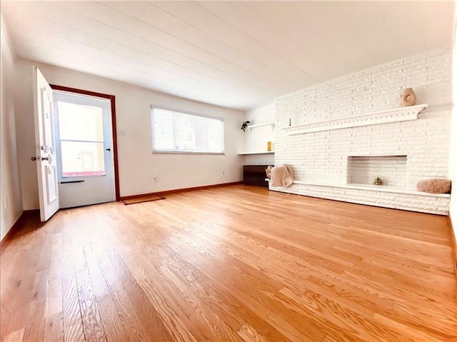 unfurnished living room with a fireplace and hardwood / wood-style flooring