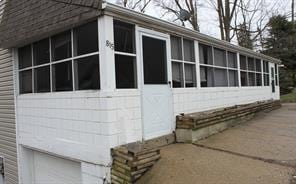 view of side of property with a sunroom