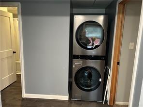 clothes washing area featuring stacked washer and dryer