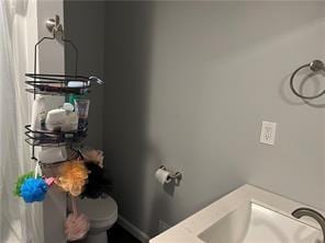 bathroom featuring toilet and sink