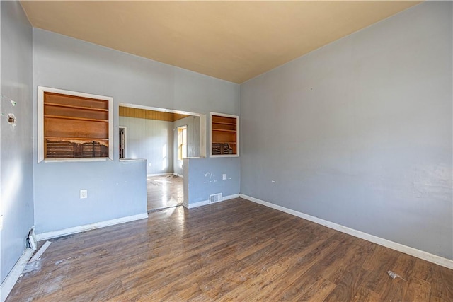 spare room featuring dark hardwood / wood-style floors