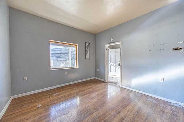 unfurnished room with hardwood / wood-style floors