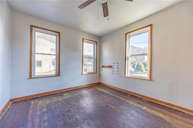 empty room with a healthy amount of sunlight and hardwood / wood-style flooring