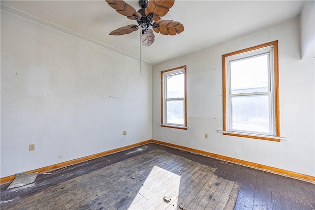 spare room with ceiling fan, plenty of natural light, and dark wood-type flooring