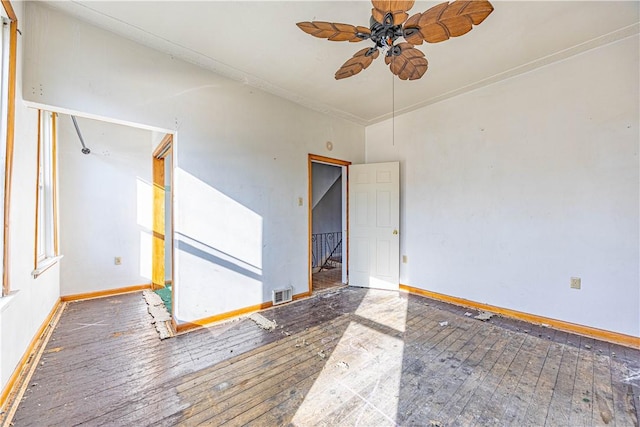 unfurnished room featuring ceiling fan and dark wood-type flooring