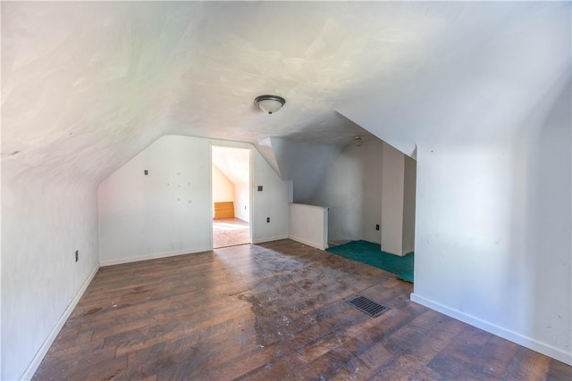 additional living space with lofted ceiling and dark wood-type flooring