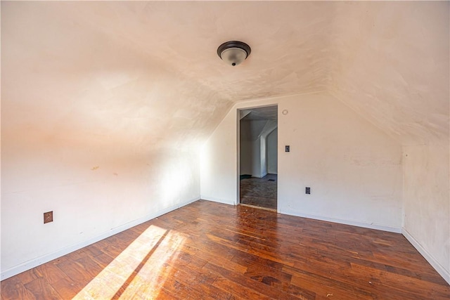 bonus room featuring lofted ceiling and dark hardwood / wood-style floors