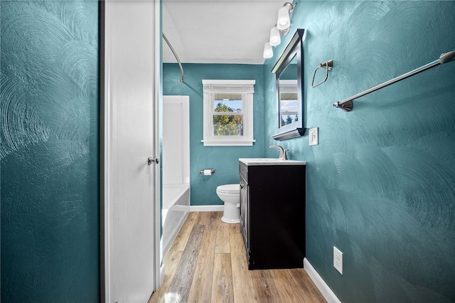 full bathroom with shower / tub combination, toilet, vanity, and hardwood / wood-style flooring