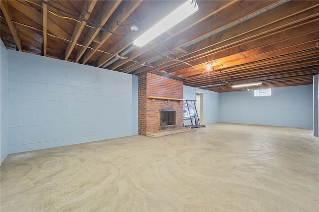 basement featuring a brick fireplace