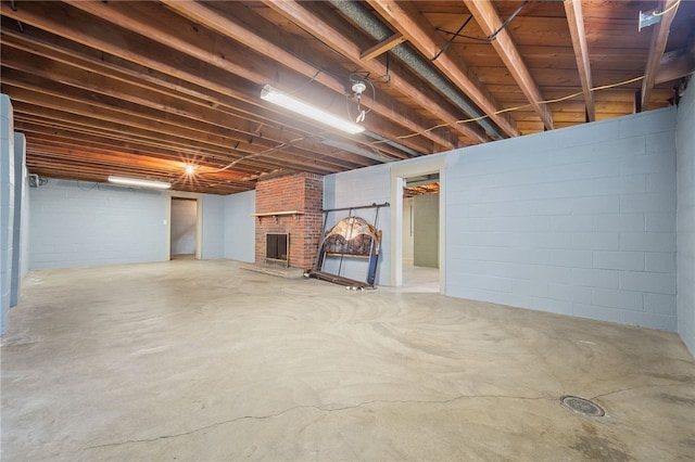 basement featuring a brick fireplace