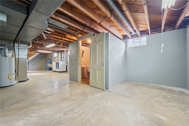 basement featuring heating unit, washer / dryer, and water heater