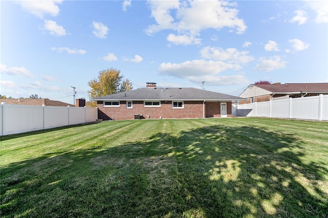 rear view of property featuring a yard