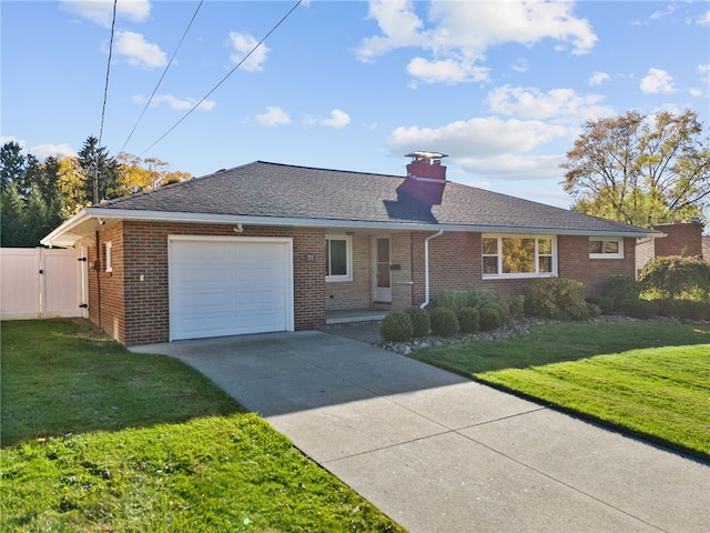 ranch-style house featuring a garage and a front lawn