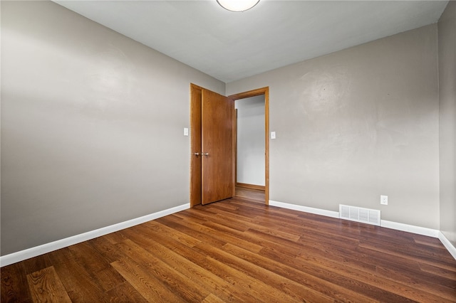 spare room with wood-type flooring