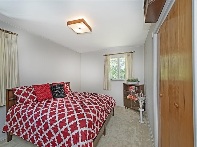 bedroom featuring light colored carpet