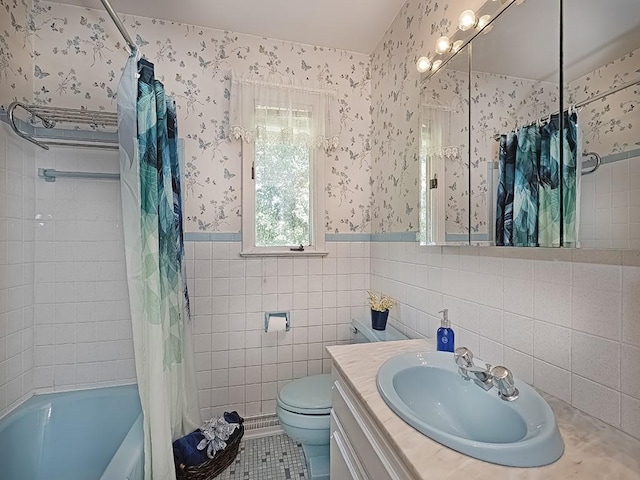 full bathroom featuring shower / bath combination with curtain, tile patterned floors, vanity, tile walls, and toilet