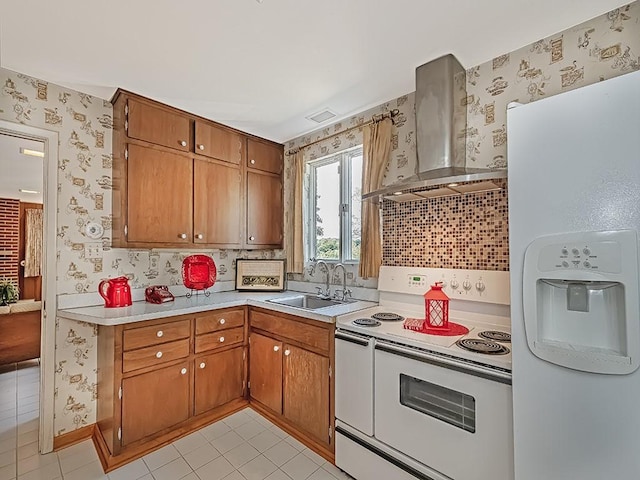 kitchen featuring tasteful backsplash, wall chimney exhaust hood, white appliances, sink, and light tile patterned floors