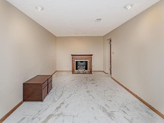 unfurnished living room featuring light carpet and a fireplace