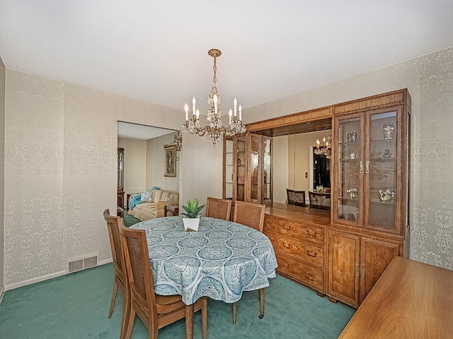 carpeted dining space with a chandelier