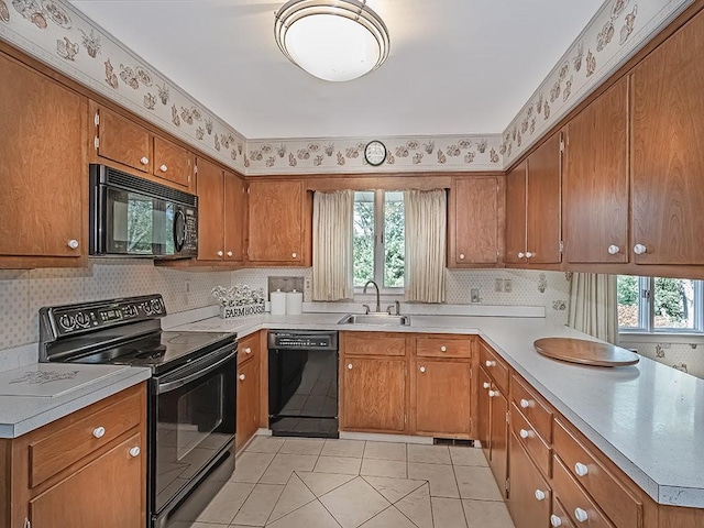 kitchen with sink, light tile patterned flooring, and black appliances