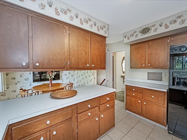 kitchen with black fridge and light tile patterned floors