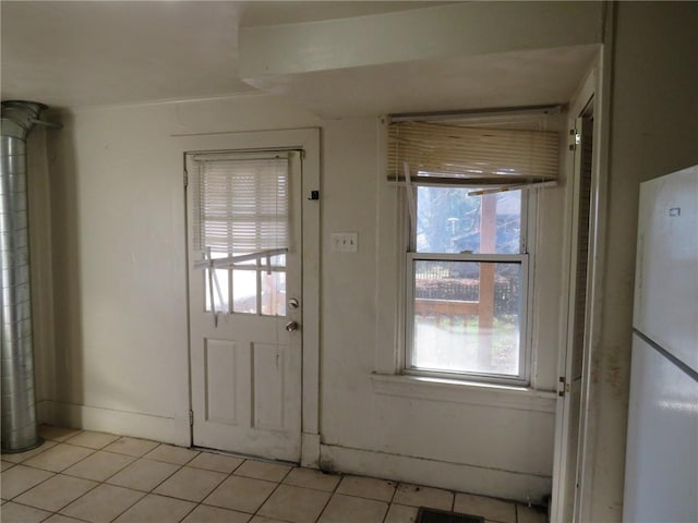 entryway with light tile patterned floors