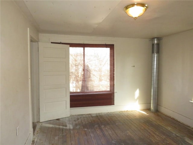 unfurnished room featuring hardwood / wood-style flooring