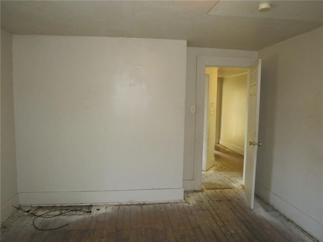 spare room with wood-type flooring