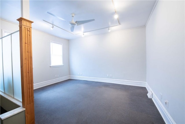 spare room featuring rail lighting, ceiling fan, and ornamental molding