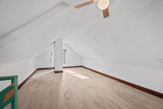 additional living space with ceiling fan, wood-type flooring, and vaulted ceiling