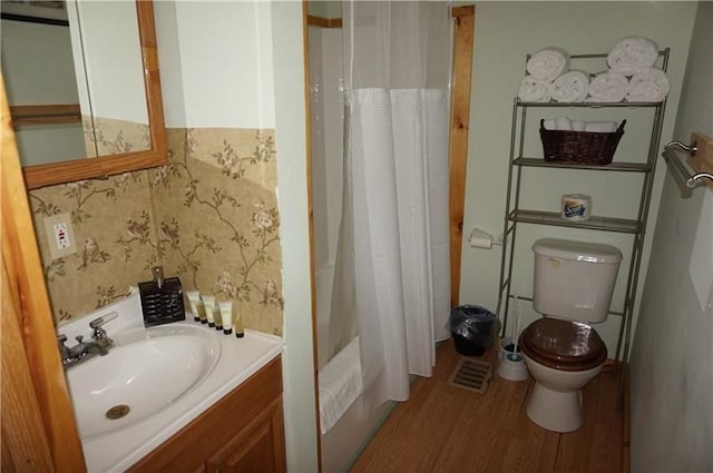 bathroom featuring hardwood / wood-style floors, vanity, and toilet