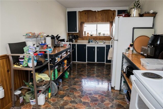 115 Ross St, Confluence Boro, PA 15424 - kitchen with a sink, white electric range oven, light countertops, and dark cabinetry