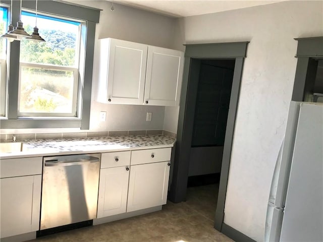 115 Ross St, Confluence Boro, PA 15424 - kitchen featuring dishwasher, freestanding refrigerator, light countertops, and white cabinetry