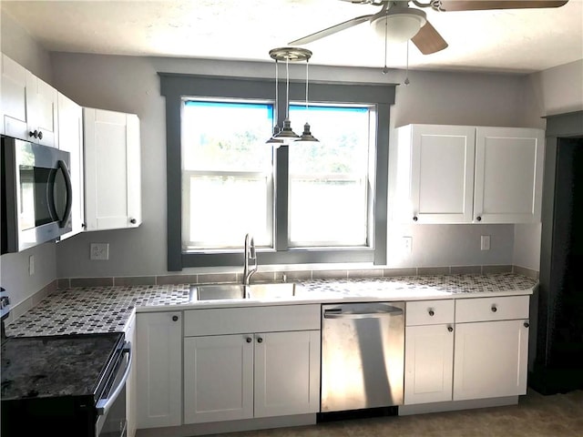 115 Ross St, Confluence Boro, PA 15424 - kitchen with stainless steel appliances, a sink, ceiling fan, white cabinetry, and decorative light fixtures