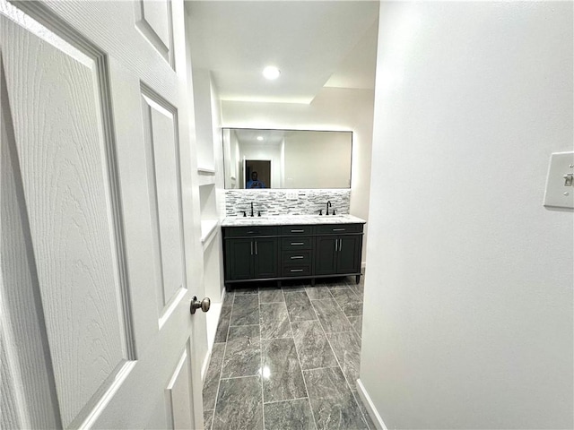 bathroom with decorative backsplash and vanity