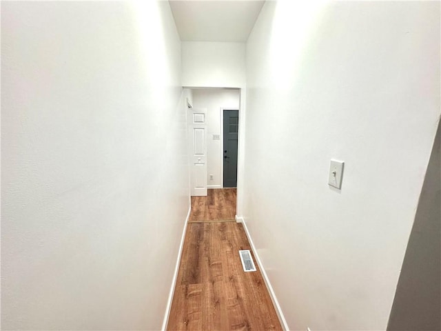 corridor featuring hardwood / wood-style floors