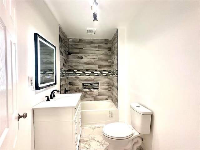 full bathroom with vanity, tiled shower / bath combo, and toilet