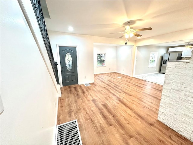 entrance foyer featuring plenty of natural light, ceiling fan, and light wood-type flooring