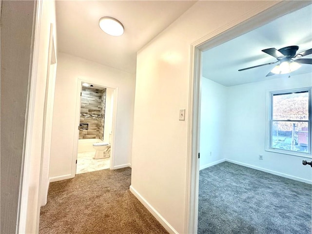 hallway with dark colored carpet