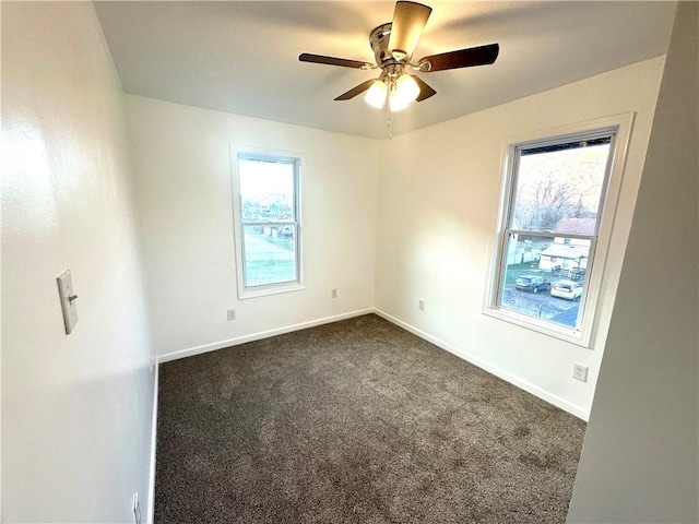 carpeted spare room featuring ceiling fan