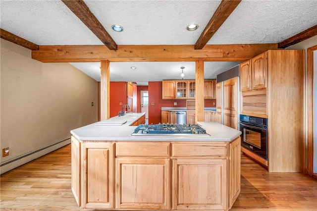 kitchen with a center island, stainless steel appliances, light hardwood / wood-style flooring, beamed ceiling, and a textured ceiling