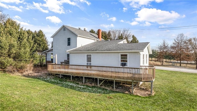 back of house with a wooden deck and a yard