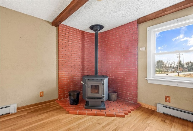 details with wood-type flooring, a textured ceiling, and baseboard heating