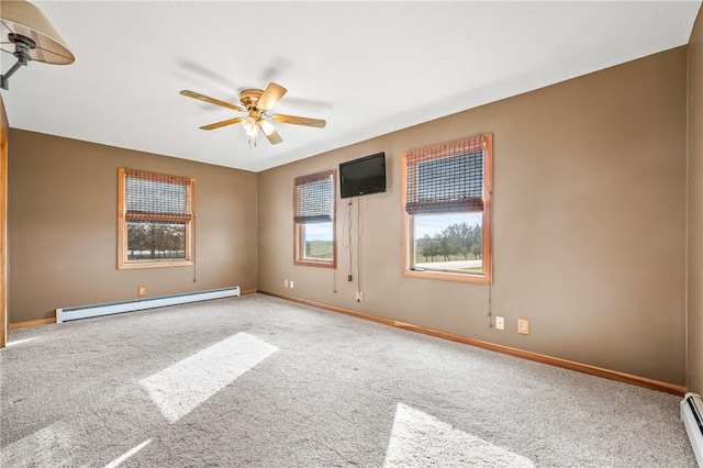 carpeted spare room featuring ceiling fan and baseboard heating