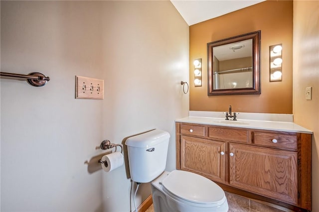 bathroom with tile patterned flooring, vanity, and toilet