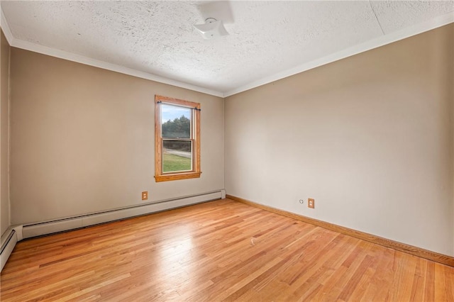 spare room with a textured ceiling, light hardwood / wood-style flooring, baseboard heating, and crown molding