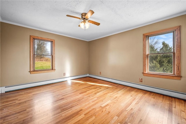 spare room featuring crown molding, light hardwood / wood-style flooring, ceiling fan, baseboard heating, and a textured ceiling