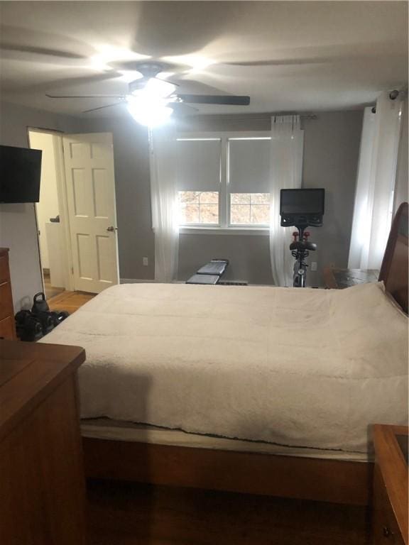 bedroom with ceiling fan and hardwood / wood-style flooring