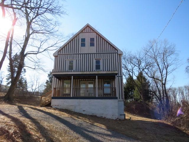 view of front facade featuring board and batten siding and a porch