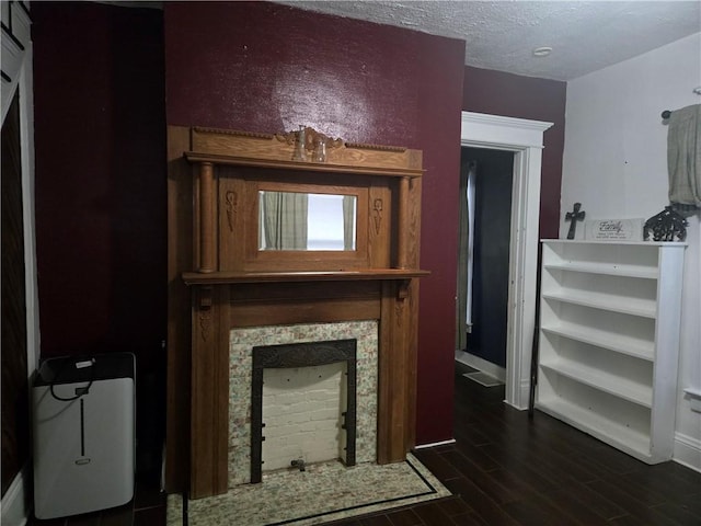 living room featuring dark wood-type flooring and a textured ceiling